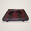 Close-up side view of the tray's glass well and striped walnut and purpleheart end grain 