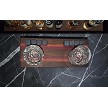 Walnut, purpleheart and red zebrawood whiskey tray with glasses and soapstone whiskey stones on a black marble bar with bottles behind it 